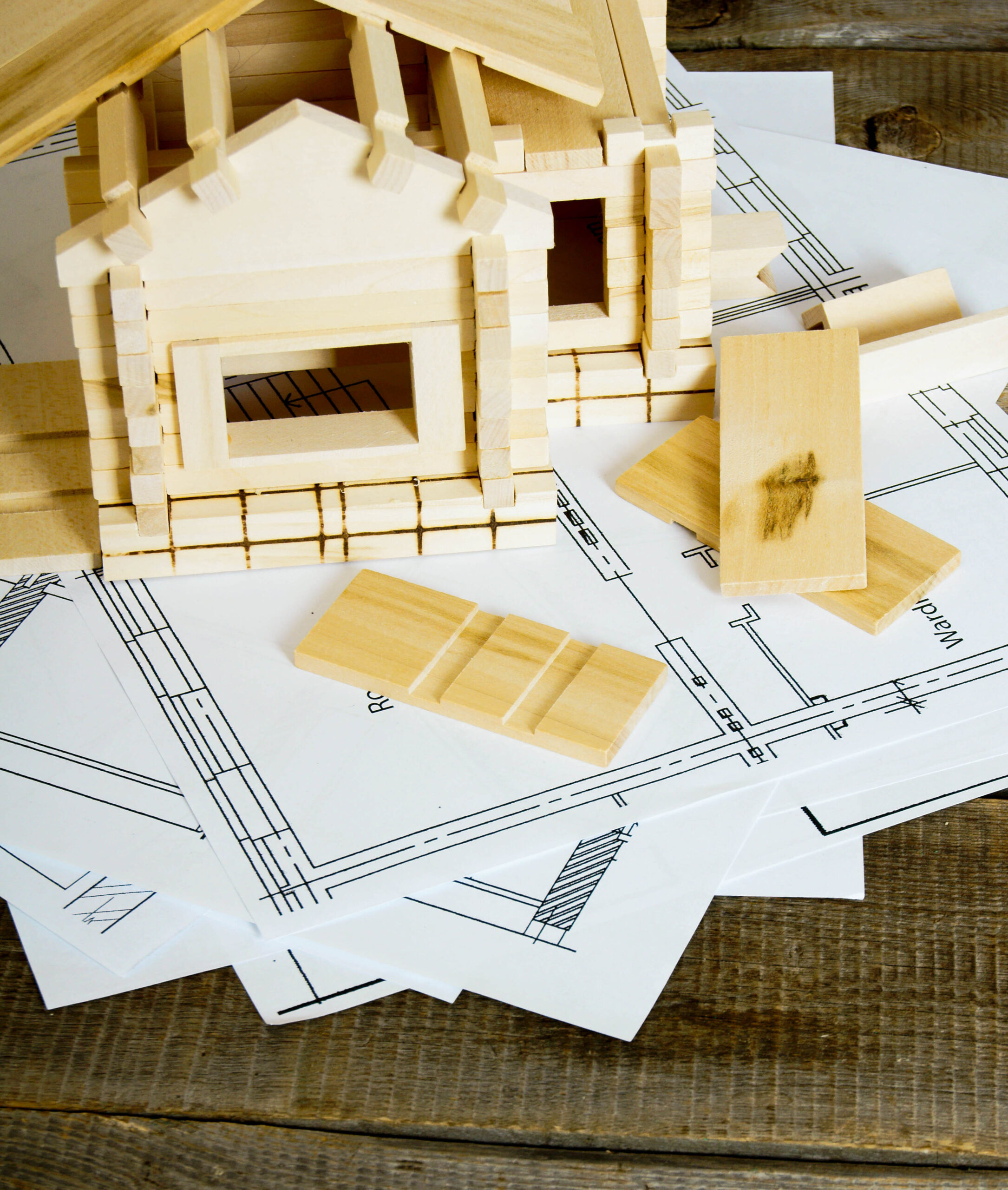 wooden-toy-house-with-blueprint-architecture-plans-2026-09-24-22-53-34-utc
